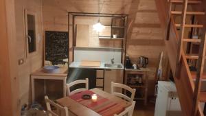 a small kitchen with a table and a sink at Casa PerAria in Paluzza