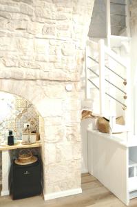 a room with a stone wall and a staircase at Casa De Amicis 24 in Sammichele di Bari +27 photos