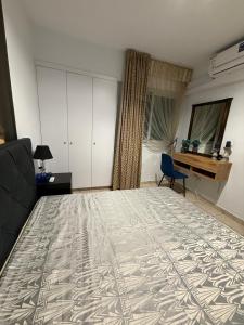 a living room with a bed and a couch and a window at Carisa rooms for holiday in Larnaca