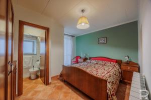 a bedroom with a bed and a bathroom with a tub at Albergo Miramonti in Comano +110 photos