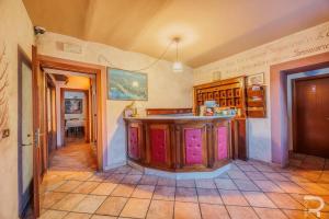 a kitchen with an island in the middle of a room at Albergo Miramonti in Comano