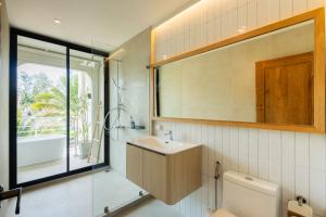 a bathroom with a sink and a toilet and a window at ELYSIUM Villa Khao Lak in Khao Lak +177 photos