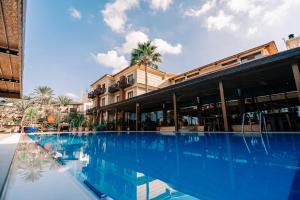 a large swimming pool in front of a building at Bella View Art Boutique Hotel in Kyrenia