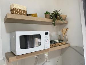 a microwave sitting on a shelf in a kitchen at Apartman Titi in Smederevo