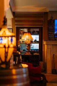 a living room with a lamp and a television at Bella View Art Boutique Hotel in Kyrenia