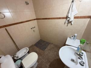 a bathroom with a white toilet and a sink at Modo soto in Villa de Soto