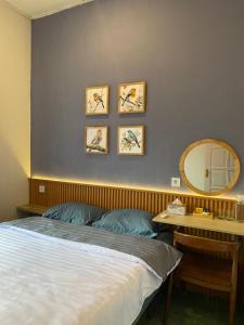 a bedroom with a bed and a mirror on the wall at Rasa Jogja Homestay in Yogyakarta +10 photos