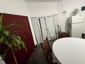 a room with a table and two windows and a plant at Modo soto in Villa de Soto