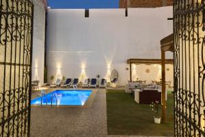 a villa with a swimming pool in a yard at White Gorf Hotel in Luxor