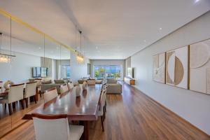 a dining room with a long table and chairs at Luxury Camps Bay Getaway in Cape Town