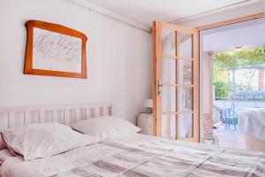 a bedroom with a bed and a sliding glass door at Apartments Mediteraneo in Zaboric
