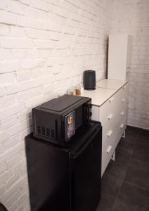 a microwave sitting on top of a black refrigerator at Dream Loft in Kłodzko