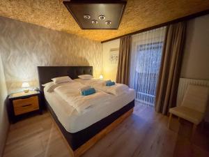 a bedroom with a large bed and a window at White Pearl Apartment in Murau