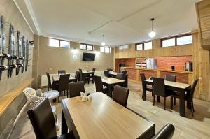 a restaurant with tables and chairs in a room at Four brother in Tbilisi City