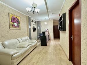 a living room with a couch and a table at Four brother in Tbilisi City +29 photos