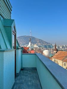 a balcony of a building with a view of a city at Four brother in Tbilisi City