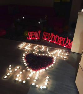 a heart made out of lights on the ground at Zirve Suit Rezidans in Talas