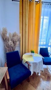 a room with two chairs and a table and a window at Wolność in Elblag