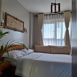 a bedroom with a large bed and a window at Spacious Studio Apartment with Swimming pool in Nairobi +13 photos