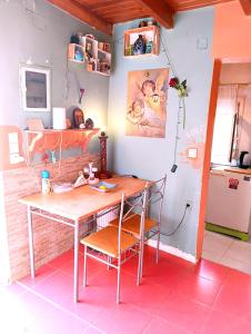 a kitchen with a table and chairs in a room at Το Μικρό Σπίτι στη Φάρμα! in Acharnes