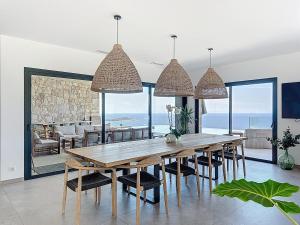 a dining room with a large wooden table and chairs at Villa A Pinnata in Albitreccia