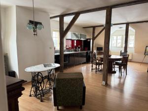a kitchen and dining room with a table and chairs at Apartmán Bonaparte in Loket
