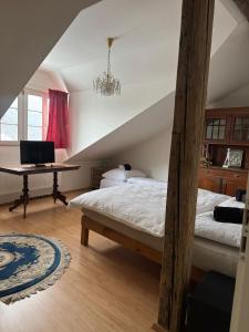 a bedroom with two beds and a desk with a computer at Apartmán Bonaparte in Loket
