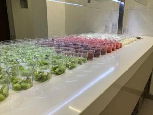 a display of green fruit in glass jars on a counter at Hotel Susuqui in Sanxenxo +64 photos