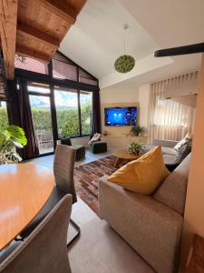 a living room with a couch and a table at Apartments Pri nas in Kobarid