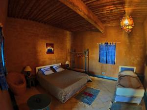 a bedroom with a bed and a chair in a room at Auberge Merzane in Merzane +53 photos
