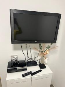 a flat screen tv sitting on top of a white cabinet at Apartma GoDeTi in Rečica ob Savinji