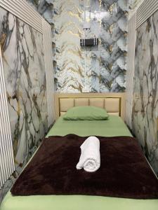 a bedroom with a bed with a towel on it at Dream Moon Hostel in Haad Rin