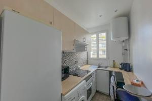 a kitchen with a sink and a counter top at Room in elegant 3-bedroom apartment near Bois de Vincennes in Paris