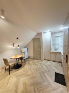 a dining room with a table and chairs and a kitchen at VHausPlunge in Plungė +26 photos