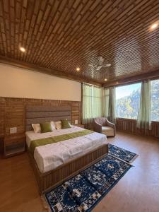 a bedroom with a large bed and a large window at Vezara homestay in Kūfrī +24 photos