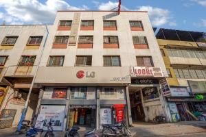 a building on a street with motorcycles parked in front at Hotel Sayba Inn - Budget Stay! in Pune