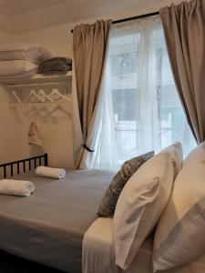 a bedroom with a bed with a window at A to B Hotel in London