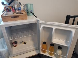 an open refrigerator with drinks inside of it at A to B Hotel in London