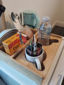 a cup of utensils on a cutting board in a sink at A to B Hotel in London +15 photos