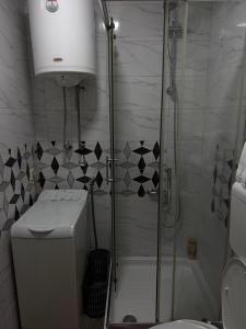 a bathroom with a shower and a toilet and a sink at AG Apartman in Kraljevo