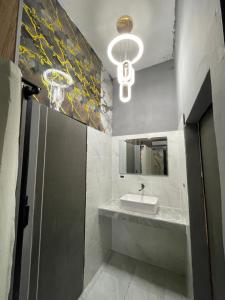 a bathroom with a sink and a mirror at Dream Moon Hostel in Haad Rin
