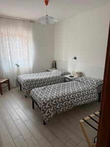 a room with two beds in a room at Casa Vacanze MarGiu Pater Domus in Goriano Sicoli