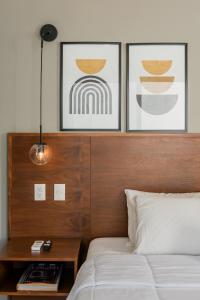 a bedroom with a bed with two pictures on the wall at CASA LIMA- Executive Design Suites in Cancún
