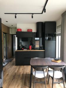a kitchen with a table and chairs in a kitchen at Paporoti House in Korostov