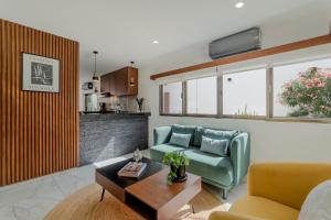 a living room with a couch and a table at CASA LIMA- Executive Design Suites in Cancún