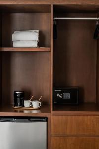 a kitchen with a microwave and two cups on a shelf at CASA LIMA- Executive Design Suites in Cancún