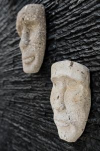 a statue of a head on a wall at CASA LIMA- Executive Design Suites in Cancún
