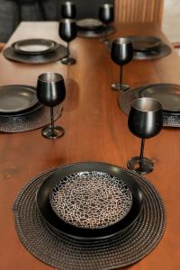 a group of black plates on a wooden table at CASA LIMA- Executive Design Suites in Cancún +62 photos