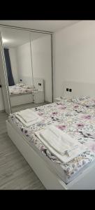 a bed in a room with two identical beds at Ultracentral Piata in Caracal