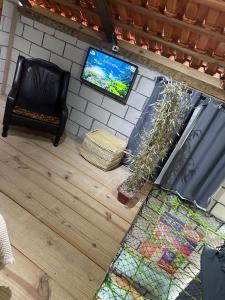 an overhead view of a room with a tv and a floor at Chalé Orquídea com vista para as montanhas in Palmeiras
